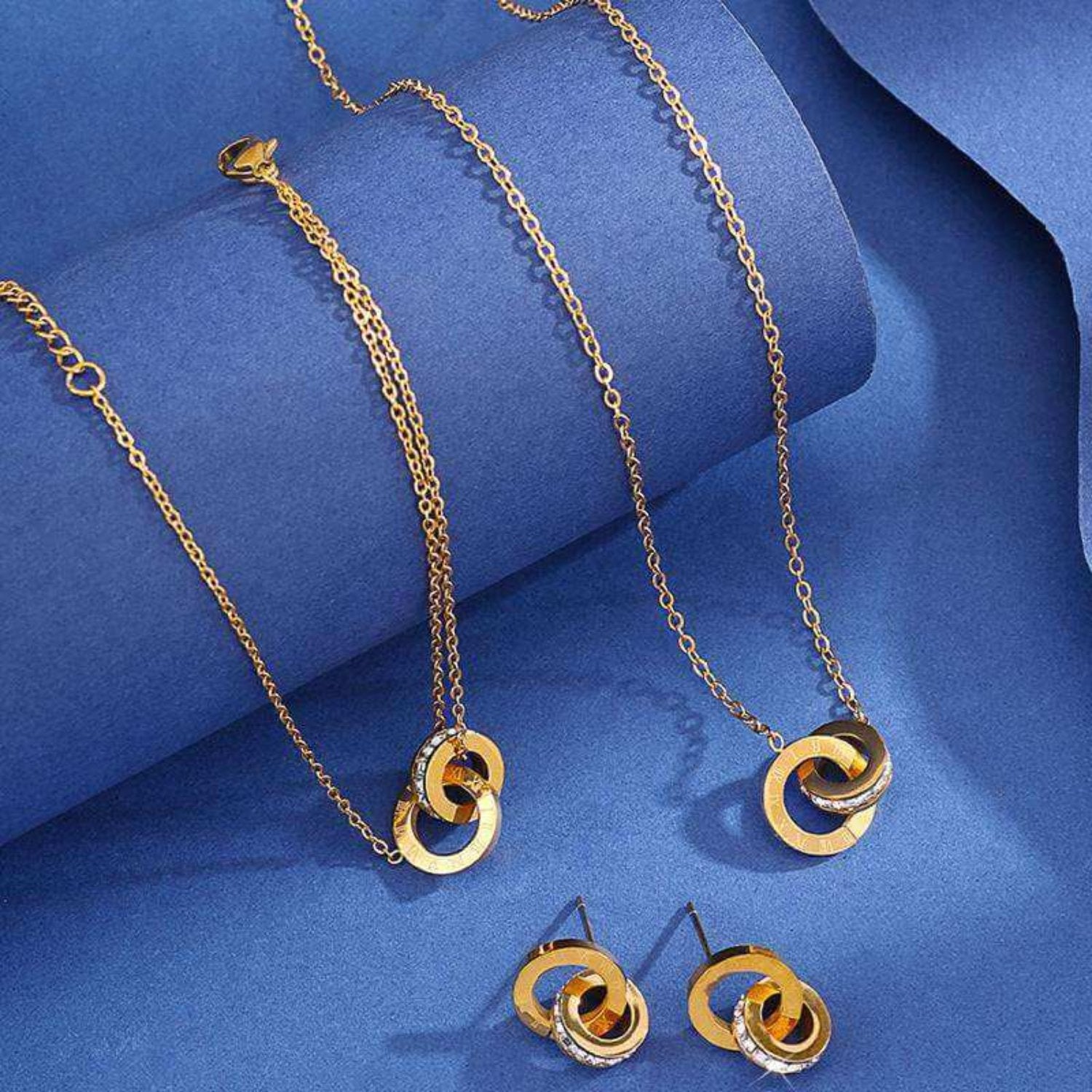 Luxurious gold jewelry set displayed on a marble background