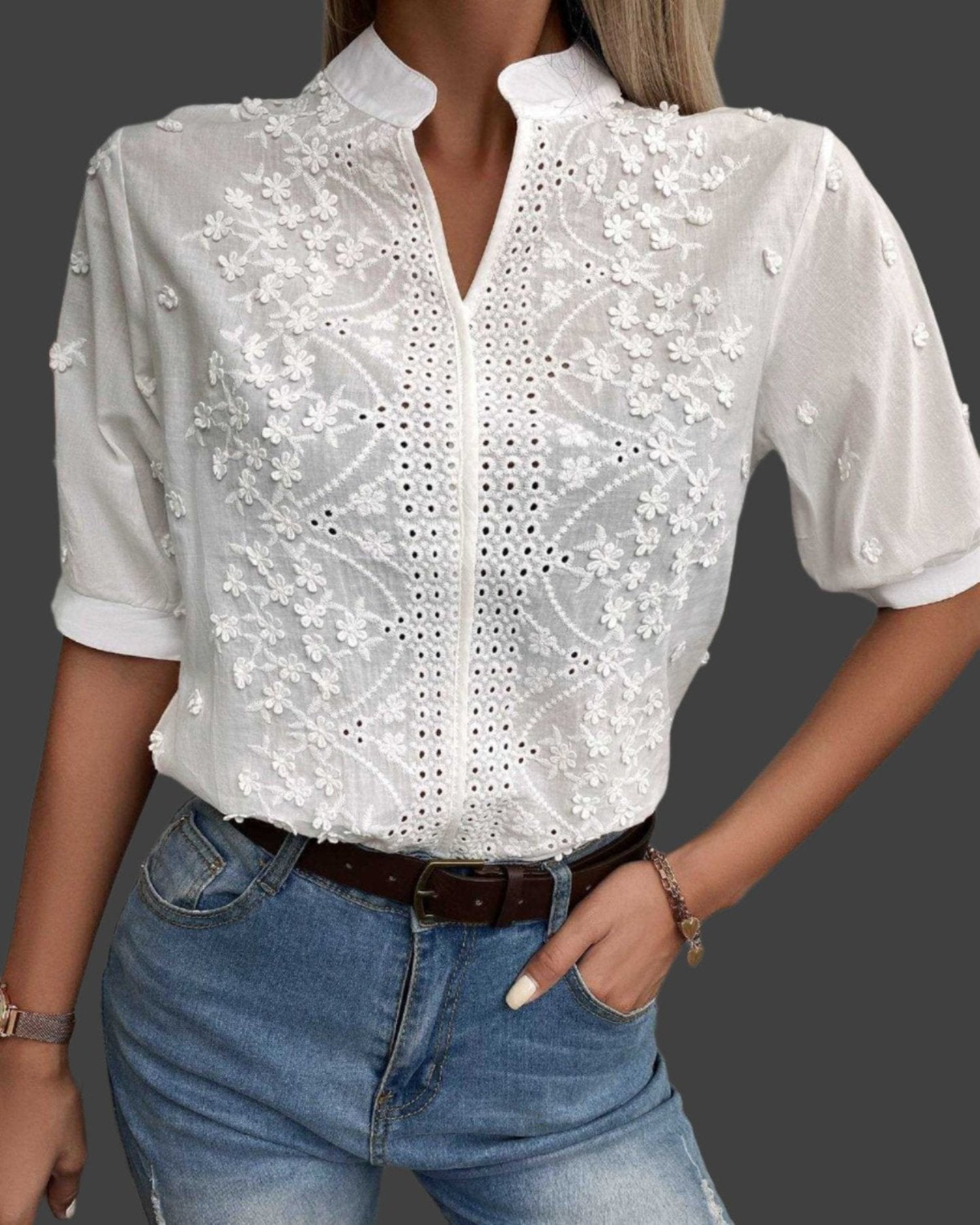 Elegant white lace blouse featuring intricate embroidery and short sleeves